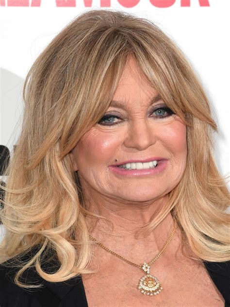 She then stripped down to a curve hugging black one-piece with a floral pattern running down her stomach as she splashed the water up into the air. . Goldie hawn 2022